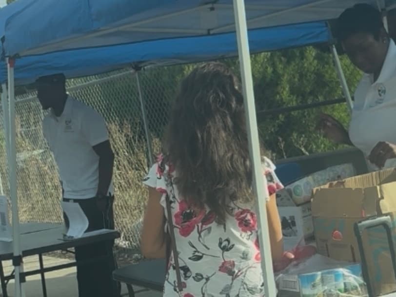 Coastal Pathways volunteers distributing groceries at a community outreach event