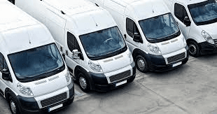 Fleet of white vans ready to provide community transportation services